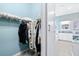 Walk-in closet view looks into the ensuite bathroom with a double sink vanity at 511 Winterside Dr, Apollo Beach, FL 33572