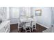 Dining area featuring white furniture, plantation shutters and stylish paintings at 511 Winterside Dr, Apollo Beach, FL 33572