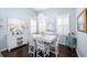Dining area with white table and chairs, coastal decor, and plantation shutters for bright light at 511 Winterside Dr, Apollo Beach, FL 33572
