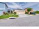 Charming yellow home featuring a well-maintained lawn and a two-car garage at 511 Winterside Dr, Apollo Beach, FL 33572