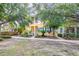Inviting two-story house with a bright yellow facade, complemented by blue shutters and a meticulously maintained front lawn at 511 Winterside Dr, Apollo Beach, FL 33572