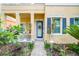 Inviting entrance with blue door, decorative wreath, manicured landscaping and a stone paver walkway leading to the front door at 511 Winterside Dr, Apollo Beach, FL 33572