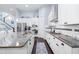 Open kitchen design with granite countertops, white cabinetry, stainless steel appliances, and seamless flow at 511 Winterside Dr, Apollo Beach, FL 33572