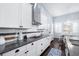 Kitchen featuring granite counters, white cabinets and subway tile backsplash, plus a view of the dining area at 511 Winterside Dr, Apollo Beach, FL 33572