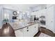 Open kitchen with granite island, stainless appliances, and views of the living area and stairway at 511 Winterside Dr, Apollo Beach, FL 33572