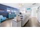 Bright living room with wood flooring, a modern ceiling fan, and blue accent wall at 511 Winterside Dr, Apollo Beach, FL 33572