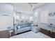 Comfortable living space showcasing a gray sofa, hardwood floors, seamlessly connecting to a modern kitchen and dining area at 511 Winterside Dr, Apollo Beach, FL 33572