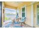 Cozy, screened-in patio with seating, ceiling fan, outdoor rug, and views of lush greenery at 511 Winterside Dr, Apollo Beach, FL 33572