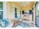 Charming, screened-in patio featuring comfortable seating, tropical flamingo rug, and outdoor decor at 511 Winterside Dr, Apollo Beach, FL 33572