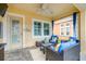 Covered patio featuring comfortable lounge furniture, ceiling fan, stone pavers, and stylish outdoor decor at 511 Winterside Dr, Apollo Beach, FL 33572