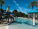 Resort style pool featuring a fun water slide, splash fountain, and ample seating under palm trees at 511 Winterside Dr, Apollo Beach, FL 33572