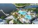 Aerial view of a resort style pool area with water slide, splash fountain, and palm trees near a lake at 511 Winterside Dr, Apollo Beach, FL 33572