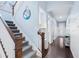 Carpeted staircase next to a hallway with light blue walls and white trim, leading into the home at 511 Winterside Dr, Apollo Beach, FL 33572