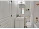 Bathroom featuring white vanity with modern sink, mirror, toilet, and tiled shower at 5205 Brighton Shore Dr, Apollo Beach, FL 33572
