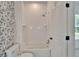 Bright bathroom features a tub/shower combination and stylish wallpaper at 5205 Brighton Shore Dr, Apollo Beach, FL 33572