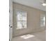 Bedroom featuring a door, carpeted floors, two windows, and geometric-patterned wallpaper at 5205 Brighton Shore Dr, Apollo Beach, FL 33572