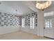 Dining room with neutral carpet, two shuttered windows, and decorative wallpaper and trimwork at 5205 Brighton Shore Dr, Apollo Beach, FL 33572