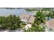 Waterfront home featuring lush landscaping, neutral paint, and a two-car garage at 5205 Brighton Shore Dr, Apollo Beach, FL 33572