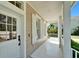 Inviting covered front porch showcasing bright white trim, railings, and columns at 5205 Brighton Shore Dr, Apollo Beach, FL 33572