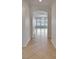 Hallway with tiled floor leading to a room with multiple windows and a view of the water at 5205 Brighton Shore Dr, Apollo Beach, FL 33572