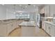 Spacious kitchen featuring white cabinets, stainless steel appliances, an island, and tiled floor at 5205 Brighton Shore Dr, Apollo Beach, FL 33572