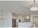 Open concept kitchen with white cabinets, stainless steel appliances, and an island with bar seating at 5205 Brighton Shore Dr, Apollo Beach, FL 33572