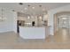 Bright kitchen with white cabinets, pendant lighting, and a marble countertop island offering style and functionality at 5205 Brighton Shore Dr, Apollo Beach, FL 33572