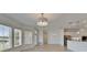 Open-concept living space with tile flooring, a contemporary chandelier, and a view of the kitchen at 5205 Brighton Shore Dr, Apollo Beach, FL 33572