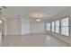 Bright and spacious living room featuring tile floors, a modern chandelier and a wall of windows at 5205 Brighton Shore Dr, Apollo Beach, FL 33572