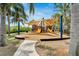 Community playground with pirate ship theme featuring slides and shade sails surrounded by palm trees at 5205 Brighton Shore Dr, Apollo Beach, FL 33572
