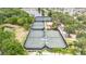 Aerial view of community tennis courts, surrounded by lush trees and landscaping at 5205 Brighton Shore Dr, Apollo Beach, FL 33572