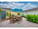 Charming backyard featuring a patio, outdoor dining, a grill, and lush landscaping, perfect for entertaining at 5410 River Sound Ter, Bradenton, FL 34208