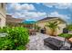Backyard paver patio features outdoor seating, grill, landscaping, and string lights at 5410 River Sound Ter, Bradenton, FL 34208