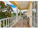 Outdoor balcony with white railing features seating, yellow siding, and views of the community pond at 5410 River Sound Ter, Bradenton, FL 34208
