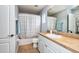 Bathroom with a shower-tub, vanity with white cabinets, and neutral tile flooring at 5410 River Sound Ter, Bradenton, FL 34208