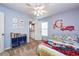 Bedroom featuring blue walls, closet, ceiling fan, and cartoon fire truck decor at 5410 River Sound Ter, Bradenton, FL 34208