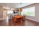 Cozy dining room with wood floors, a large window, and a wooden table with seating for six at 5410 River Sound Ter, Bradenton, FL 34208