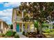 Charming two-story home with a colorful front door, columns, and nicely landscaped front yard at 5410 River Sound Ter, Bradenton, FL 34208