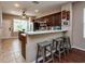 Open kitchen with bar seating, stainless steel appliances, and tile flooring at 5410 River Sound Ter, Bradenton, FL 34208