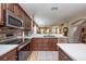 Open kitchen with stainless steel appliances, a tile backsplash, and a view to the dining area at 5410 River Sound Ter, Bradenton, FL 34208