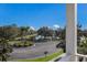 Scenic view overlooking a calm lake from a balcony, showcasing lush landscaping and clear blue skies at 5410 River Sound Ter, Bradenton, FL 34208