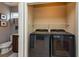Convenient laundry room with modern washer and dryer units, next to a toilet at 5410 River Sound Ter, Bradenton, FL 34208