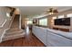 Spacious living room featuring wood floors, a ceiling fan, and a staircase at 5410 River Sound Ter, Bradenton, FL 34208