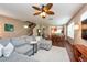 Spacious living room with hardwood floors, a ceiling fan, comfortable seating, and an open concept design at 5410 River Sound Ter, Bradenton, FL 34208