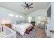 Bedroom featuring a large bed, ceiling fan, and multiple windows for natural light at 5410 River Sound Ter, Bradenton, FL 34208