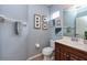 Stylish powder room with wood vanity, framed art, and neutral walls at 5410 River Sound Ter, Bradenton, FL 34208
