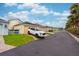 View of the streetscape with attached garages and a SUV parked in the driveway at 5410 River Sound Ter, Bradenton, FL 34208