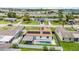 Aerial view of home showcasing pool, solar panels, backyard, and surrounding neighborhood at 6370 Elmhurst Dr, Pinellas Park, FL 33782
