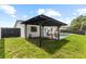 A backyard features a pergola, a pool and a privacy fence at 6370 Elmhurst Dr, Pinellas Park, FL 33782