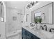 Contemporary bathroom boasts double sinks with marble countertops and a tiled walk-in shower at 6370 Elmhurst Dr, Pinellas Park, FL 33782